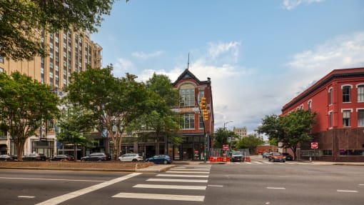a city street with a red brick building with a yellow sign on the side of it