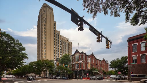 a view of a city street with a tall building in the background