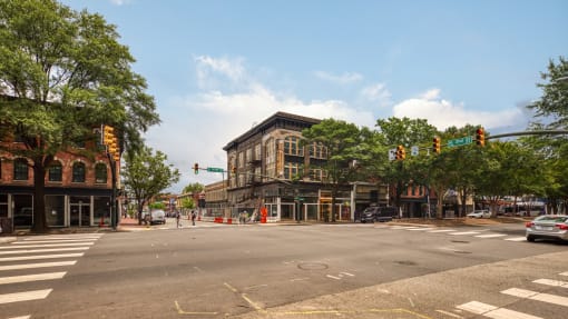 a city street with a brown building on the corner of a street