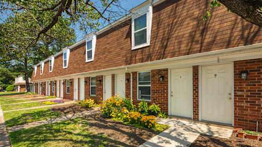 A row of houses with white doors and windows.