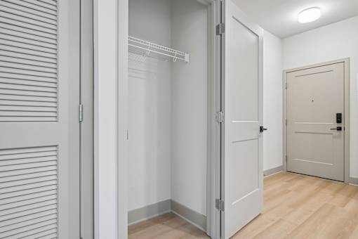 A white door is open to a hallway.