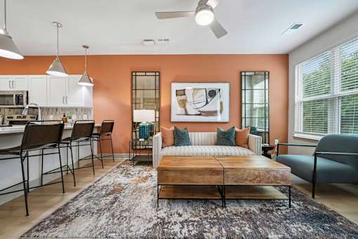 A bedroom with a bed, a couch, and a dining table.