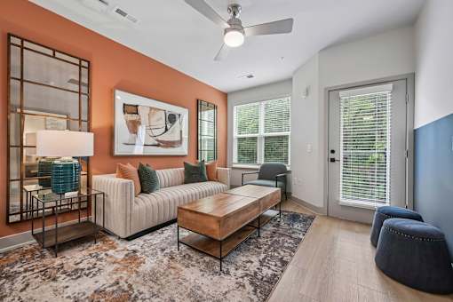 A living room with a sofa, a coffee table, and a rug.