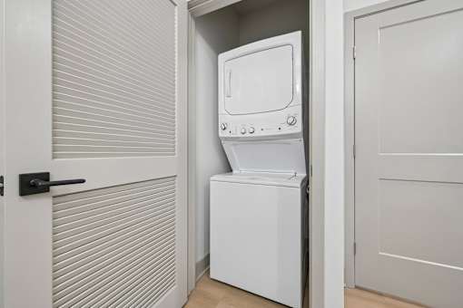 A white dishwasher is placed in a small kitchen.