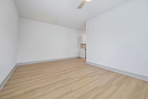 A room with wooden flooring and a ceiling fan.