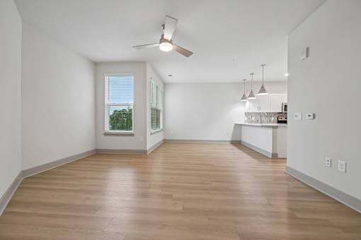 A room with wooden floors and a ceiling fan.