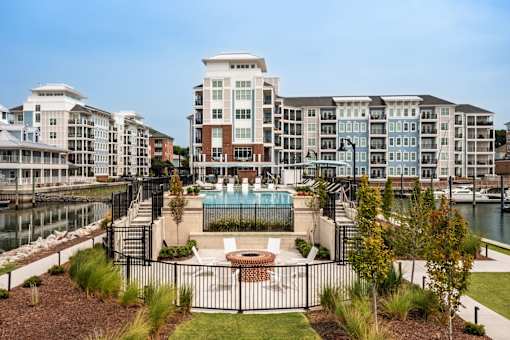 A view of a pool and a building with a fence around it.