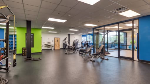 a large fitness room with cardio machines and weights at The Hudson, Richmond, 23224