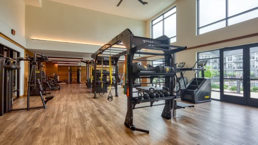 a gym with weights and exercise equipment and windows at Ainsworth, Richmond