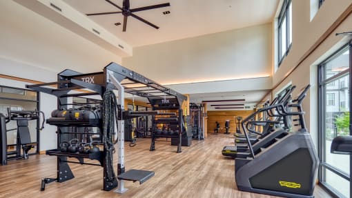 a gym with treadmills and other exercise equipment on a wood floor at Ainsworth, Richmond