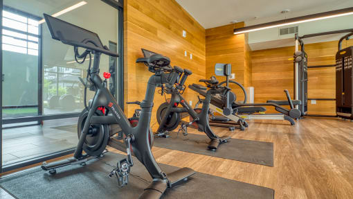 a gym with three exercise bikes in the lobby of a building at Ainsworth, Virginia, 23228
