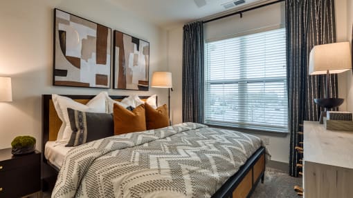 an example of a bedroom with a bed and a window at Aura Stonebridge, Richmond, VA 23225