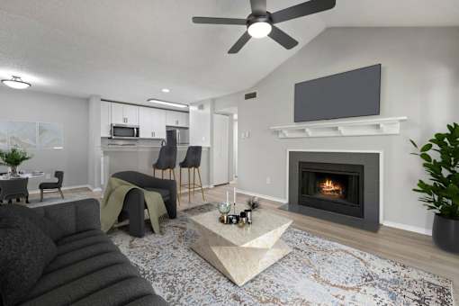 A modern living room with a grey sofa, a fireplace, and a television.