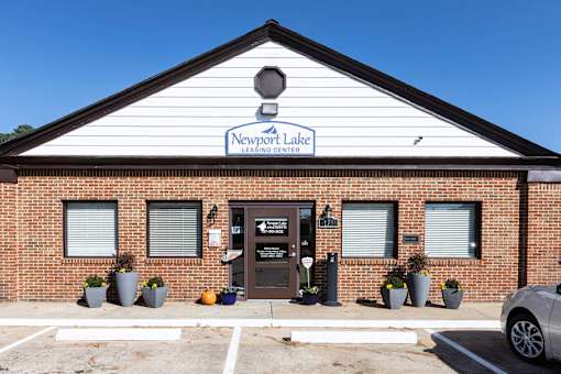 The front of a building with a sign that says Newport Lake Learning Center.