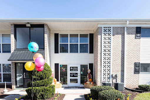 A building with a balloon decoration in front.