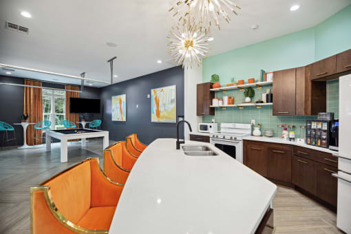 a kitchen and dining room with a white table and orange chairs
