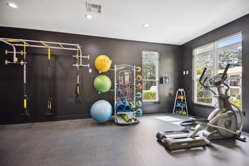 a home gym with exercise equipment and a window
