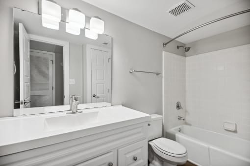a bathroom with a sink toilet and a mirror at Shellbrook, Raleigh