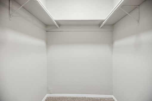 an empty room with white walls and a white ceiling