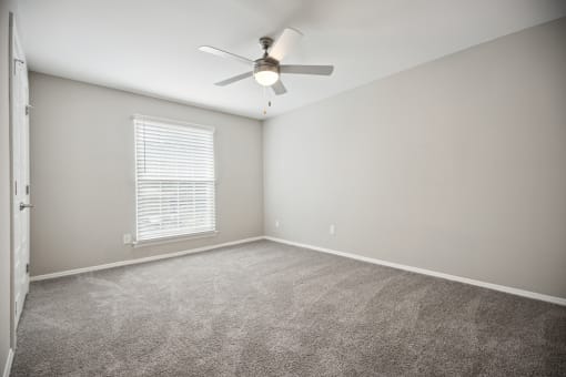 an empty room with a ceiling fan and a window at Shellbrook, North Carolina, 27609