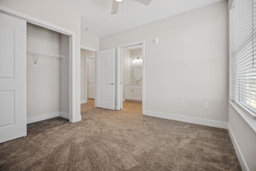 Discover the perfect blend of comfort and functionality in our spacious bedrooms featuring ample closet storage and natural lighting at Centro at Pine Nash, Wilson, NC