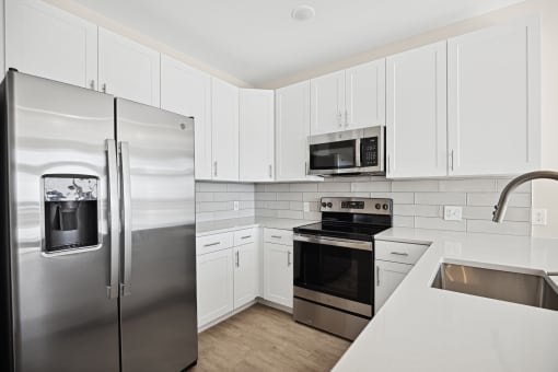 Featured B1 Floor Plan Kitchen designed with energy efficient appliances and quartz countertops Centro at Pine Nash, Wilson, NC