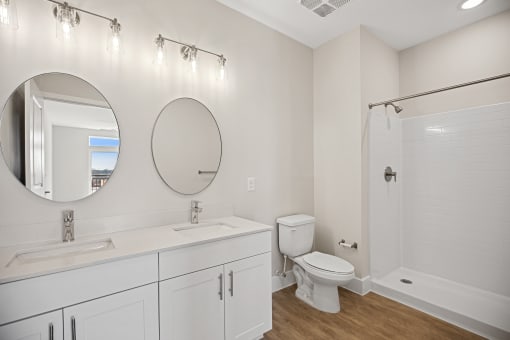 Modern designed bathroom interiors featuring custom vanities and stand-up shower options at Centro at Pine Nash, Wilson, NC