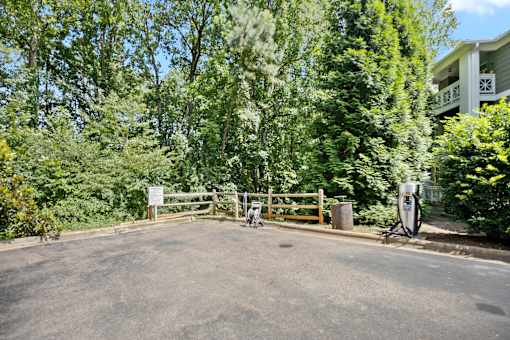 A sign is on a gate in front of a house.
