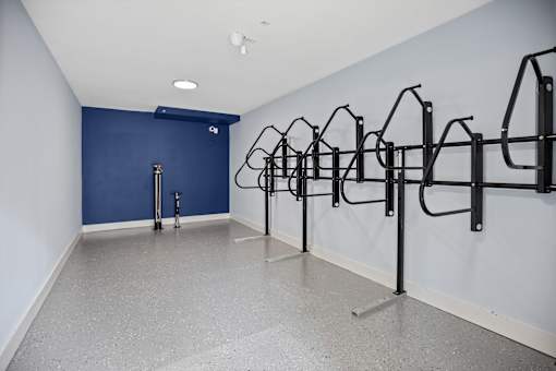 A gym with a row of black pull up bars.