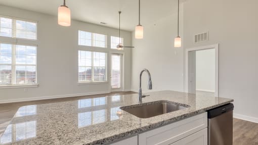 a kitchen with granite counter tops and a sink at The Bella at Westchester, Midlothian, 23113