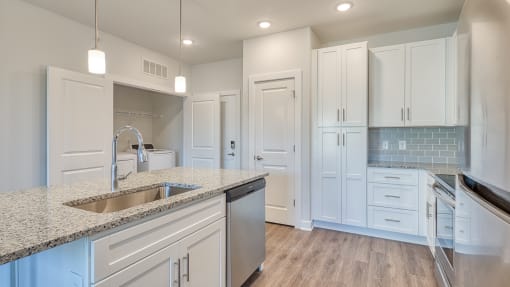 a kitchen with white cabinets and granite counter tops and a sink at The Bella at Westchester, Midlothian, VA, 23113