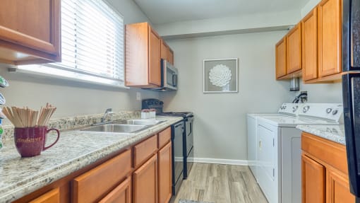 a kitchen with a counter top and a window