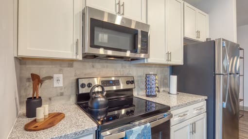 an updated kitchen with stainless steel appliances and granite counter topsat The View at Blue Ridge Commons Apartments, Roanoke