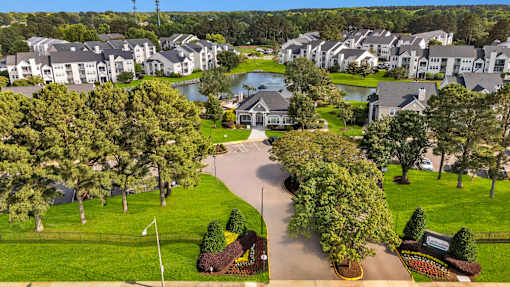 A residential area with houses and a lake.