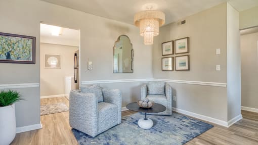 a living room with two chairs and a table