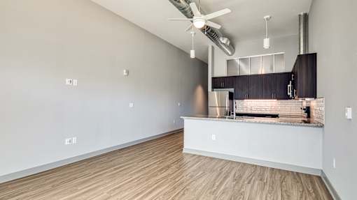 A kitchen area with a stainless steel refrigerator and a countertop.