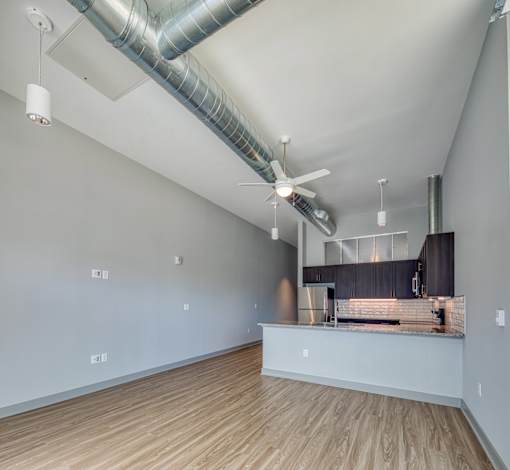 A kitchen area with a counter and a fan.