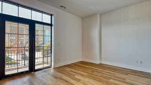 A room with a sliding glass door leading to a balcony at Aviator Lofts, Newport News, Virginia 23602