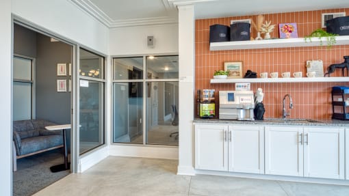 a kitchen with white cabinets and a sliding glass door at The Bella at Westchester, Midlothian