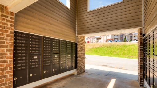 the lockers on the side of a building with a driveway