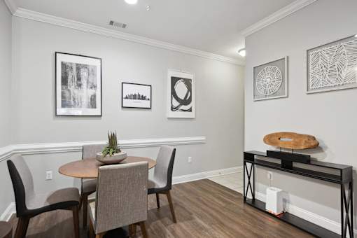 A dining room with a table and chairs.