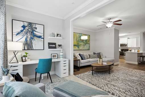 A modern living room with a blue chair and a white desk.