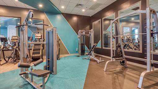 A gym with a variety of equipment including a leg press machine.