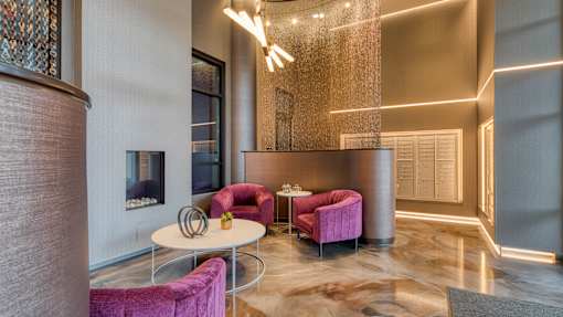 A modern living room with a pink sofa and a white coffee table.