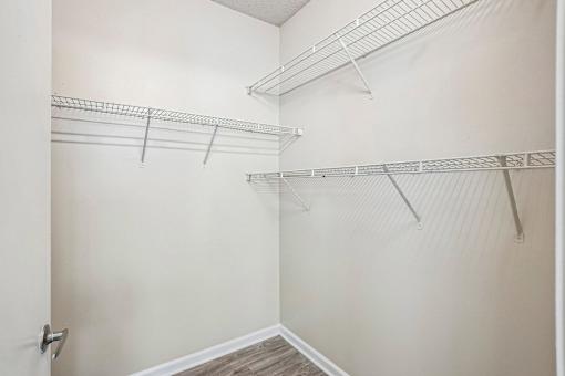 A walk-in closet with shelving and a door.