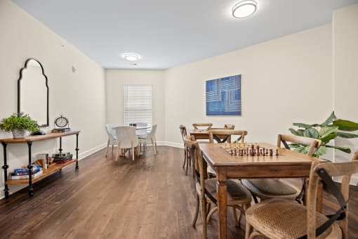 a dining room with a table and chairs and a chess board