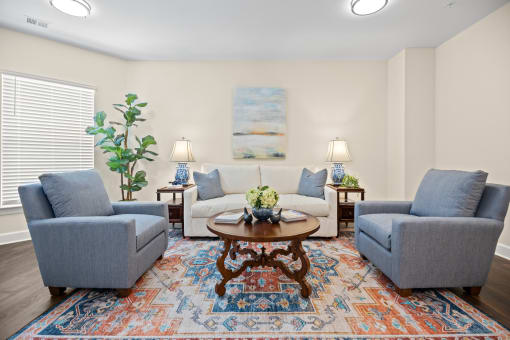 a living room with couches and chairs and a table