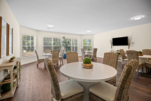 a living room with a table and chairs and a television