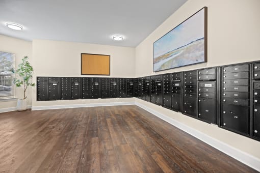 a lockers room with wood floors and a painting on the wall