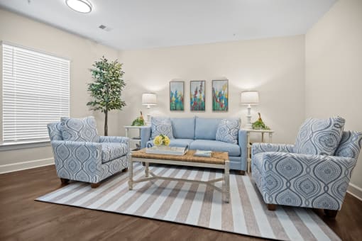 a living room with couches and chairs and a rug